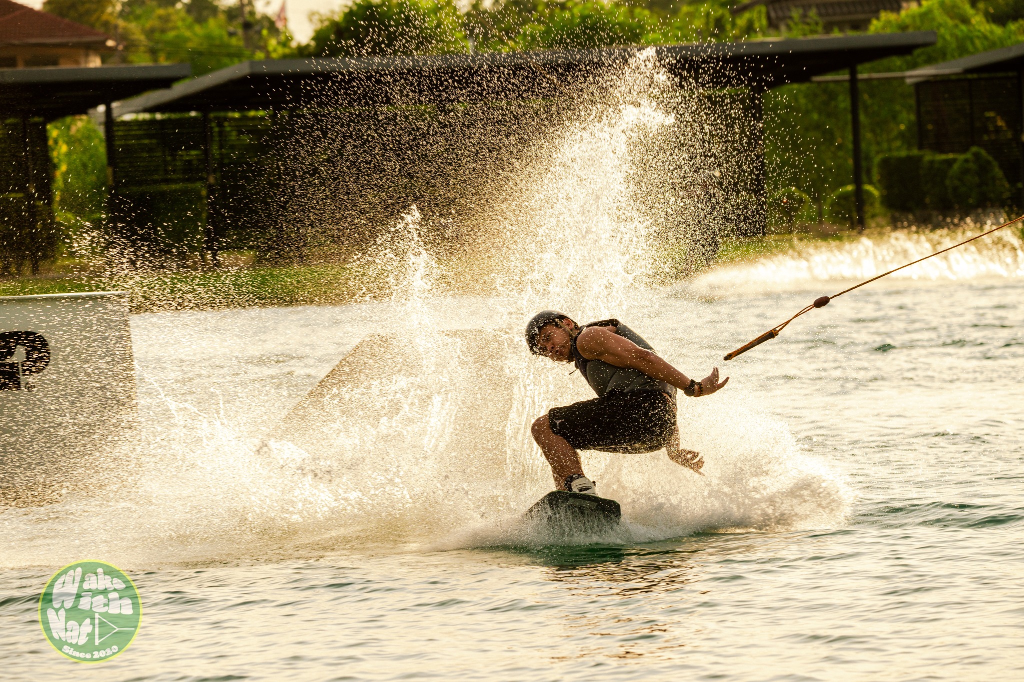Splash shot - wakeboarder clearing a rail at ESC Thai Wake Park
