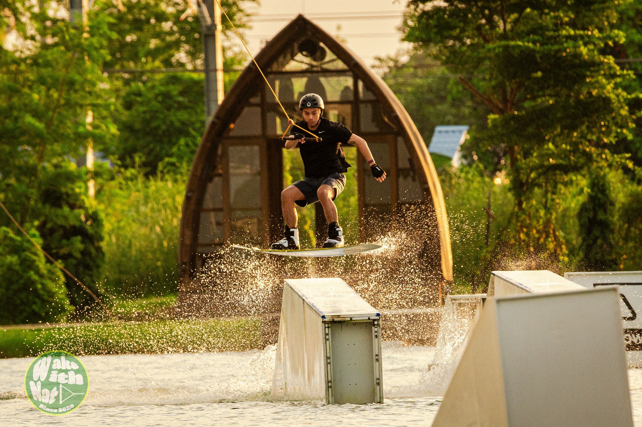 Rider throwing a toeside trick at ESC cable wake park Thailand