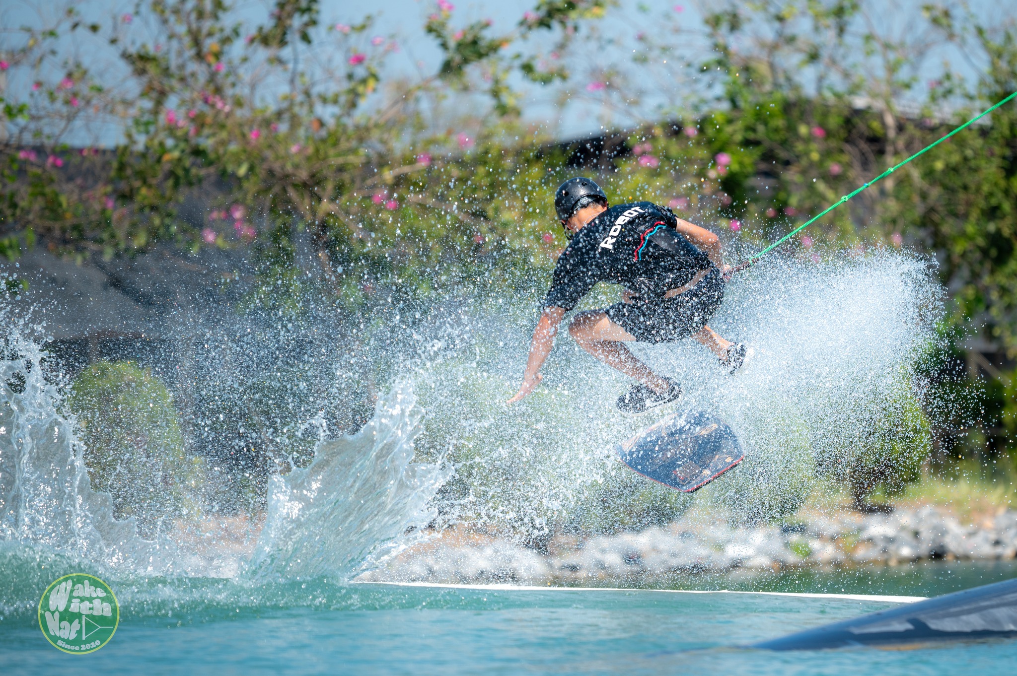 Rider throwing a heelside trick at Little Plant Wake Park Thailand