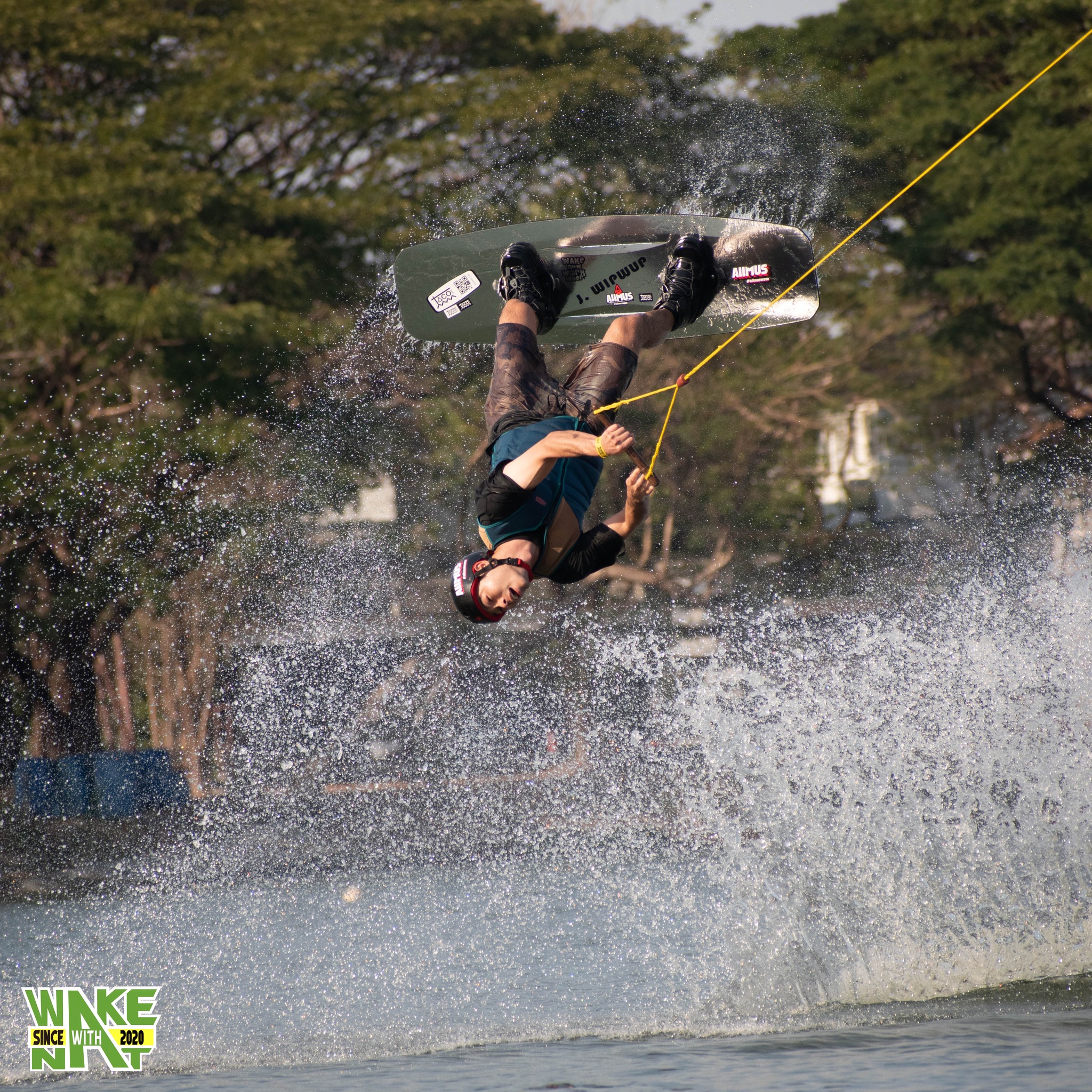 Wakeboarder launching off a kicker at Taco Lake cable wake park Thailand
