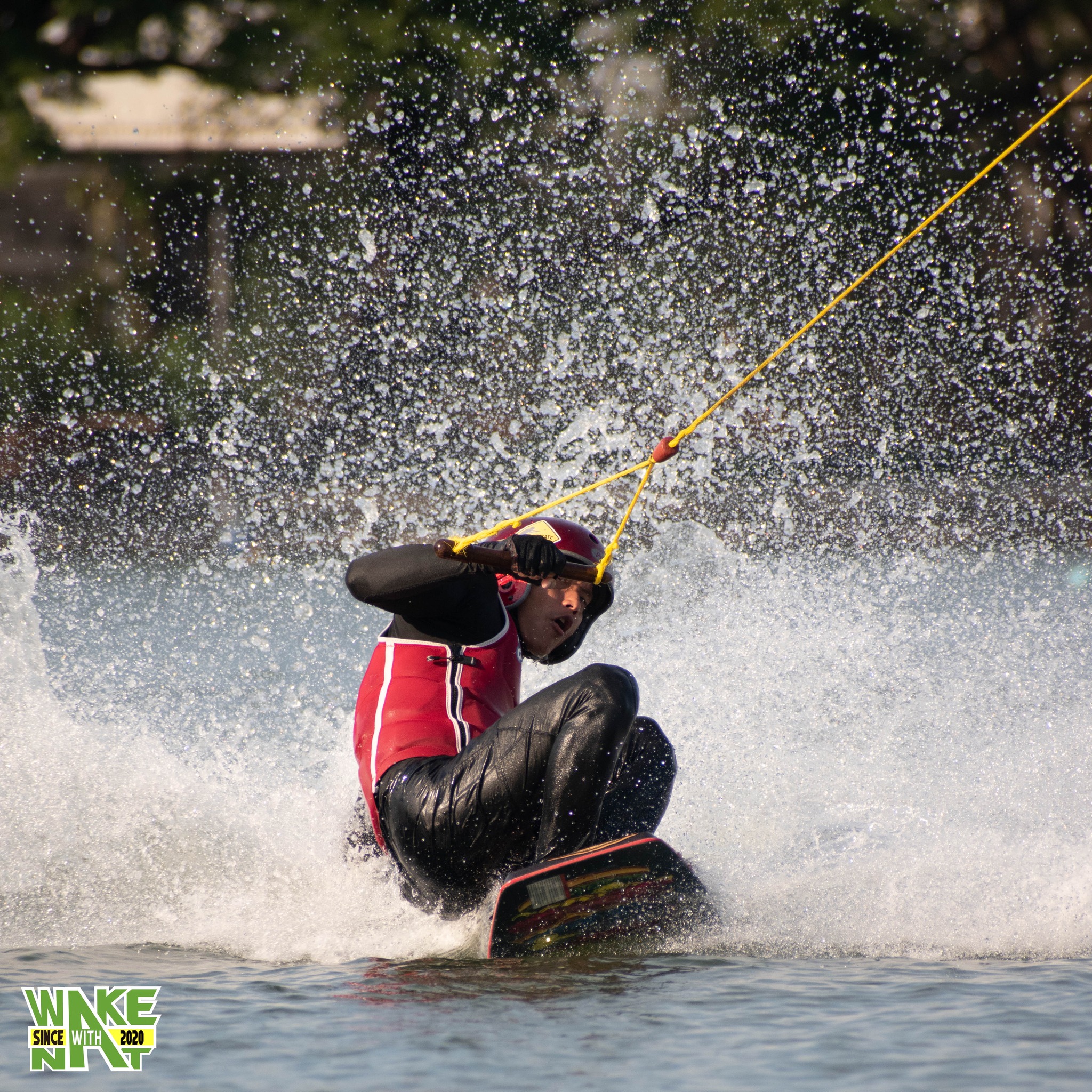 Splash shot - wakeboarder hitting a rail feature at Taco Lake Thailand
