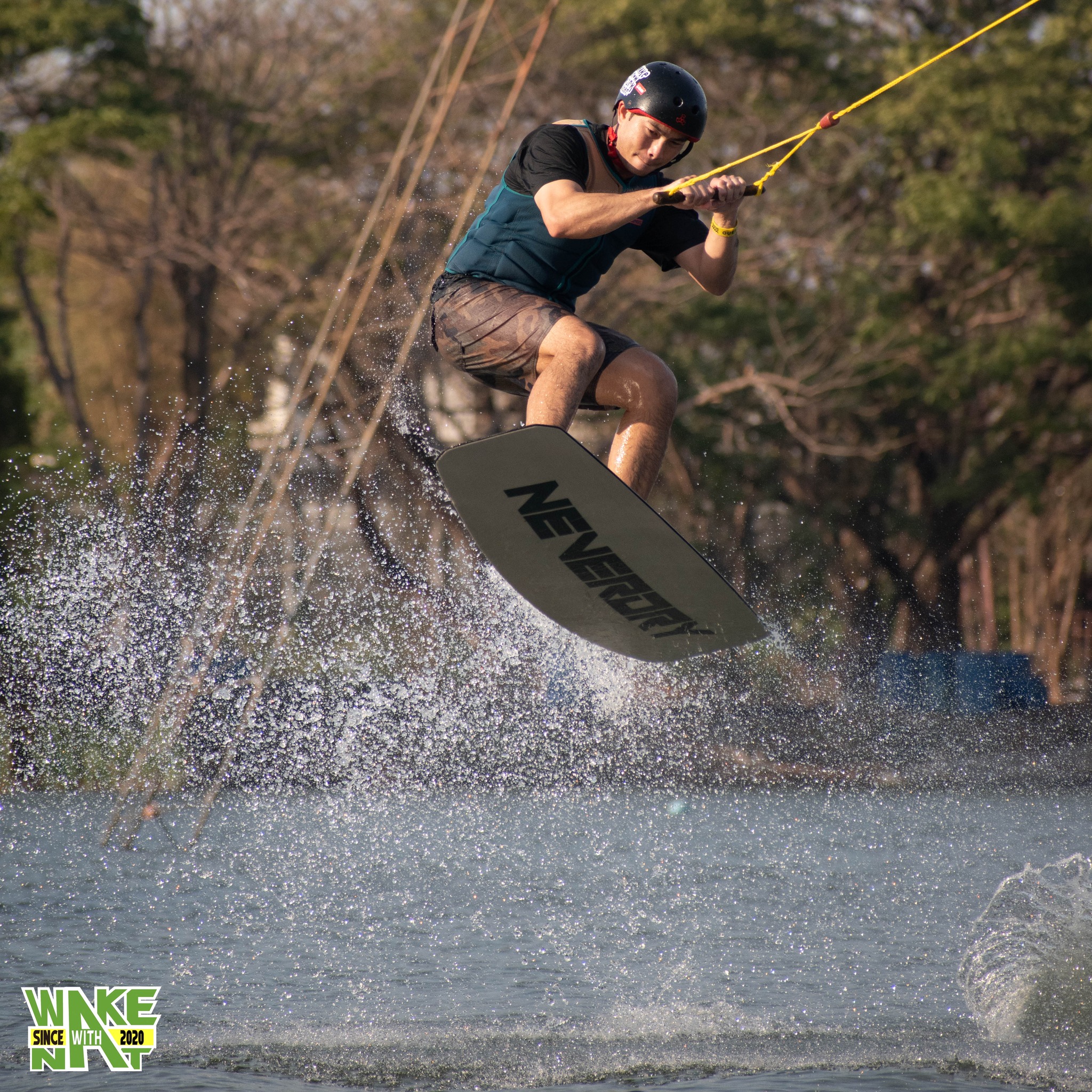 Rider throwing a heelside trick at Taco Lake - wakeboarding Thailand