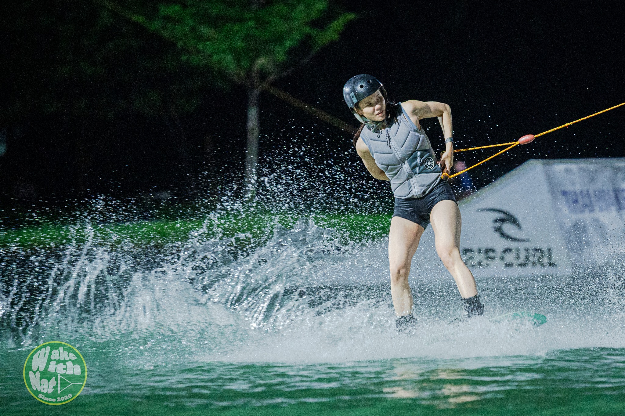 Splash shot of a wakeboarder hitting the flat bar at Thai Wake Park