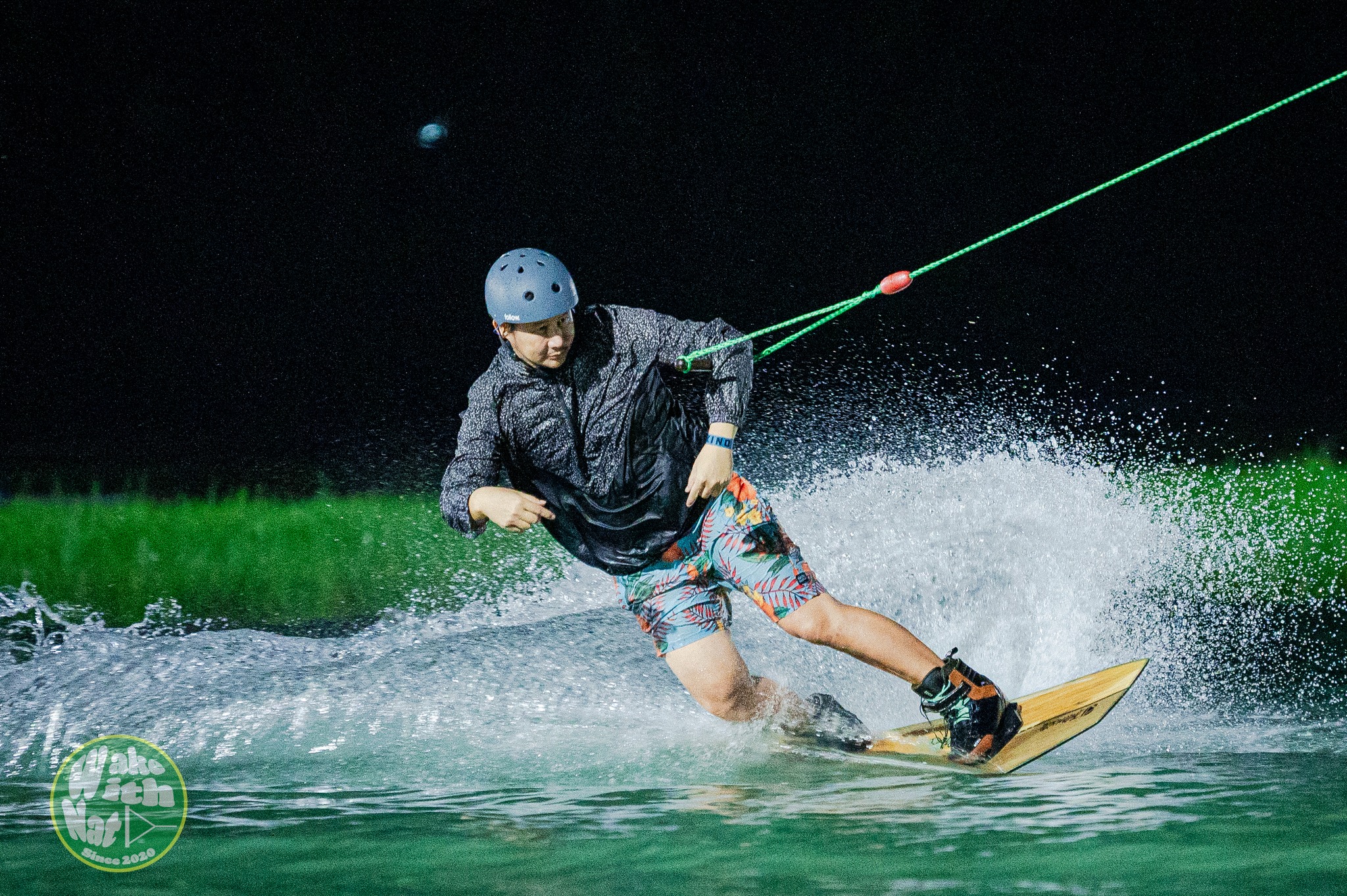 Splash shot of a wakeboarder hitting the flat bar at Thai Wake Park