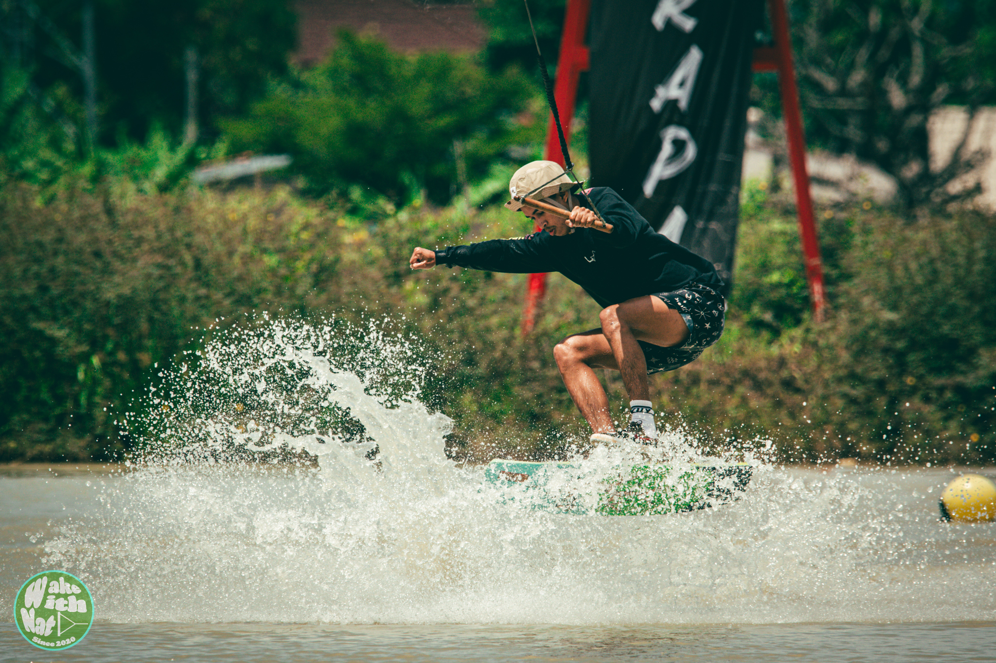Splash shot - wakeboarder hitting a feature at Varapa Wakepark Thailand