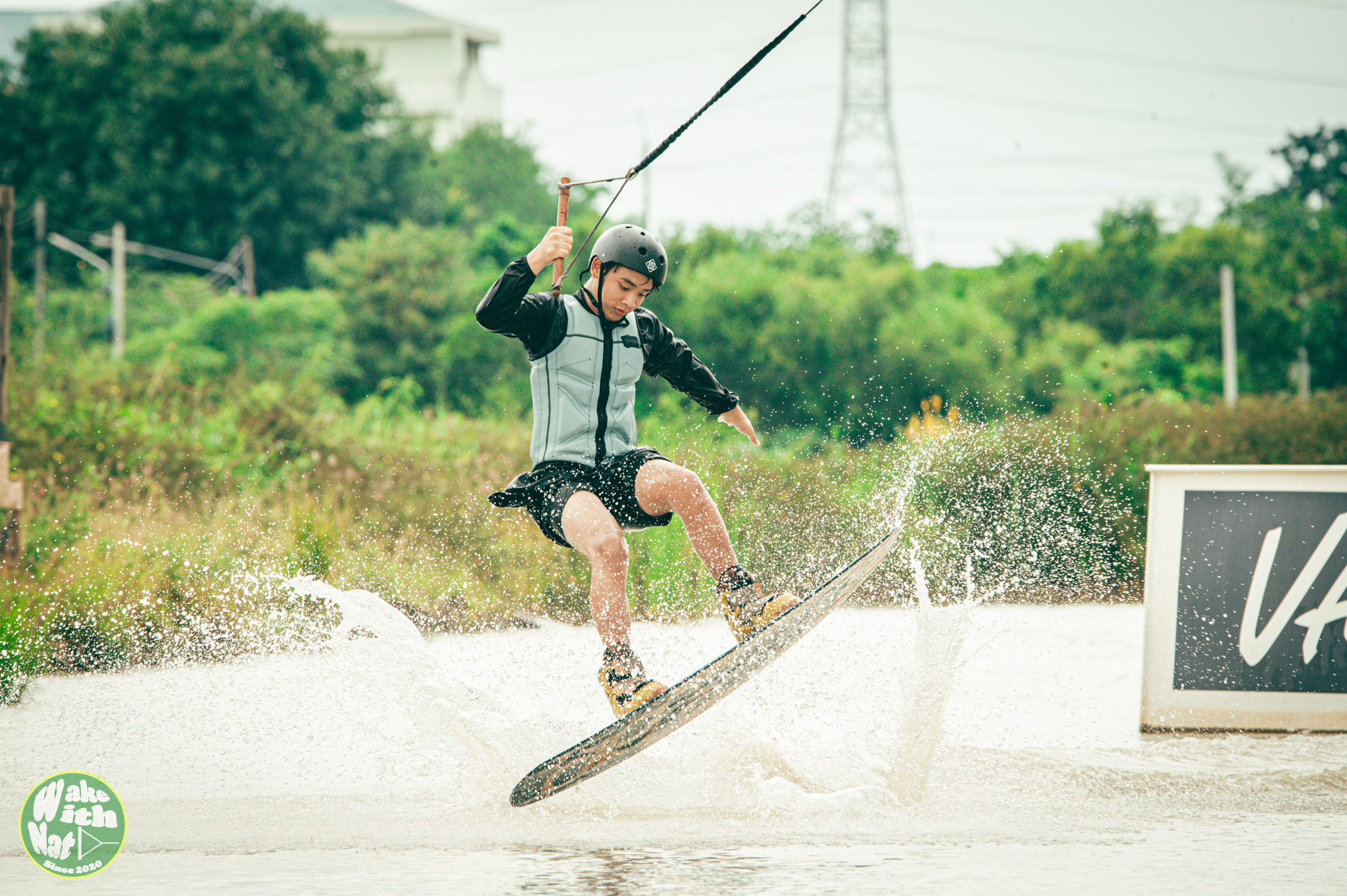 Wakeboarder launching off a kicker at Varapa Wakepark Thailand
