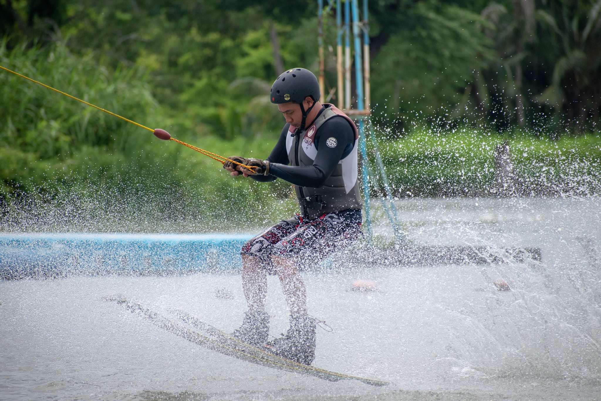 Splash shot - wakeboarder hitting a rail at Zanook Wake Park Thailand